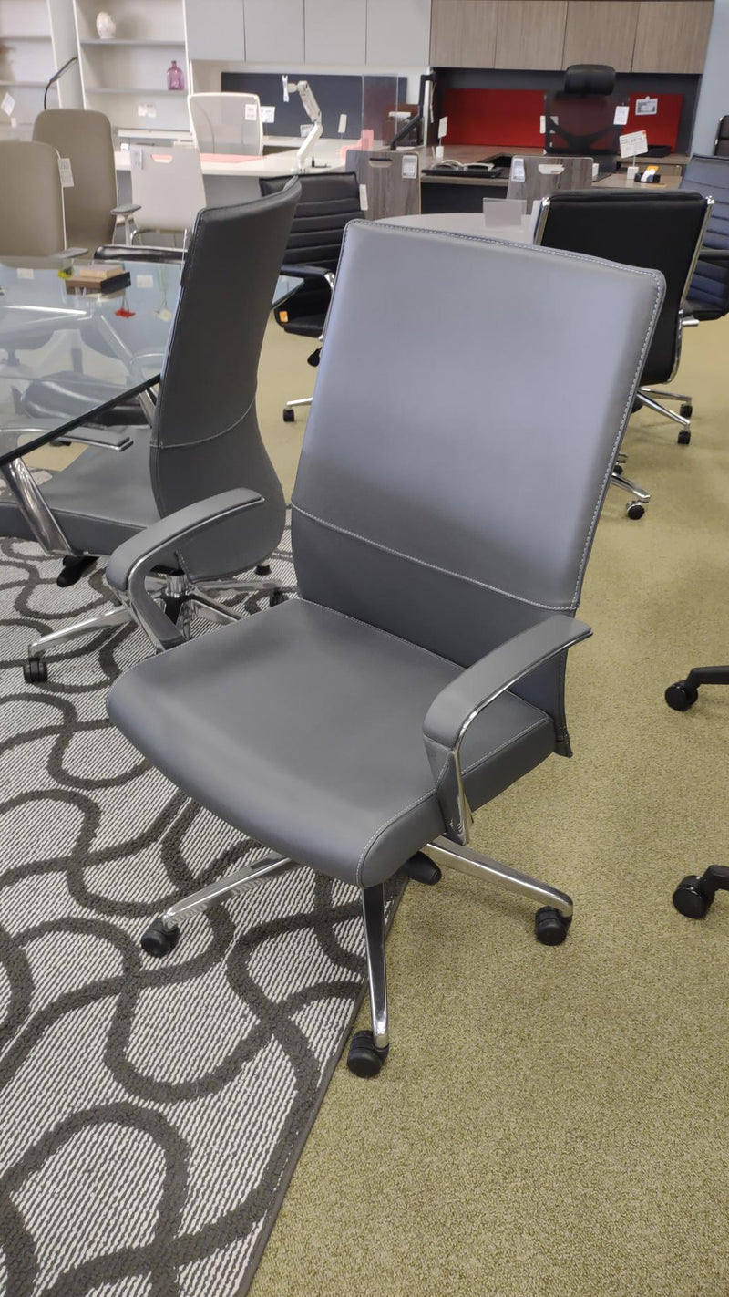 USED Gray Leather conference chair with fixed arms and mid back.