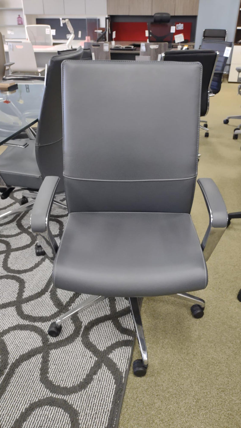 USED Gray Leather conference chair with fixed arms and mid back.